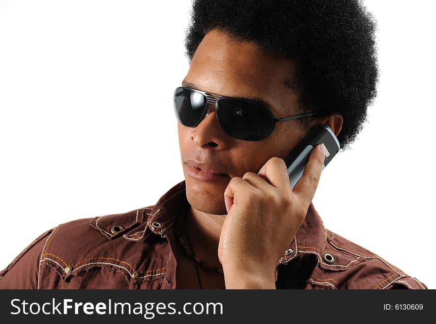 Portrait of young trendy african man using a cell phone - isolated. Portrait of young trendy african man using a cell phone - isolated