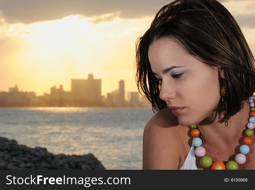 Portrait of young fashionable woman relaxing at sunset - havana skyline on the background. Portrait of young fashionable woman relaxing at sunset - havana skyline on the background