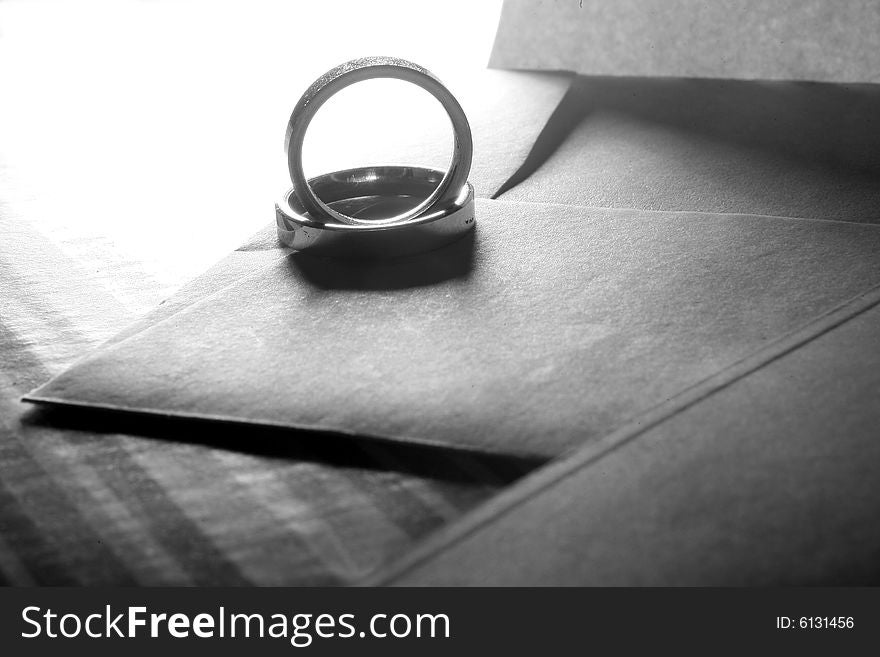 Two wedding rings on an envelope