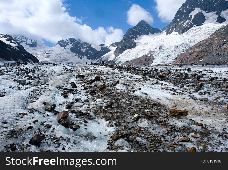 Glacier with rocks and sky with clouds