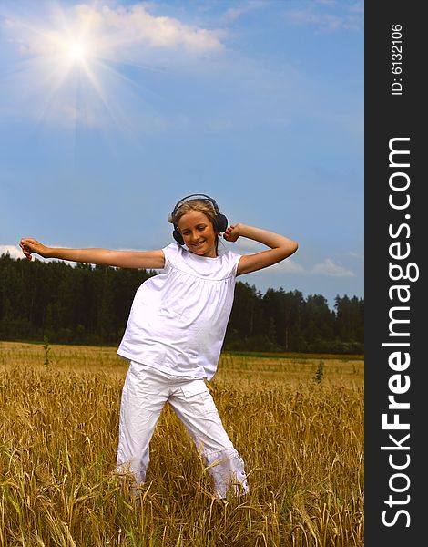 Beautiful teenager girl dancing on wheat's field