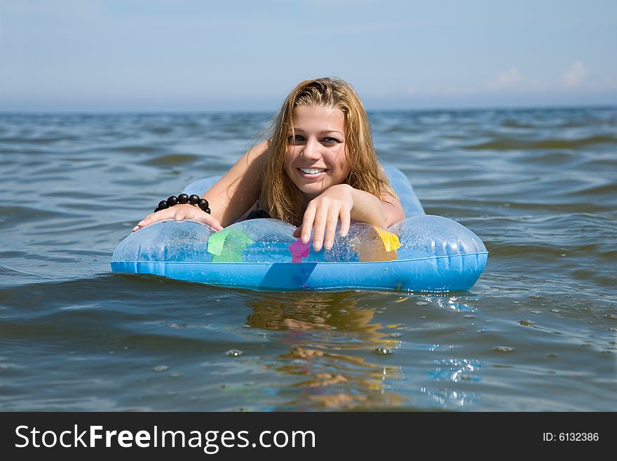 Beautiful Girl Swimming On Mattress