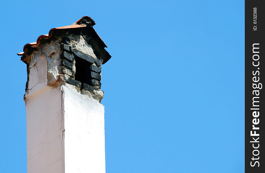 Old smoky chimney isolated over blue sky. Old smoky chimney isolated over blue sky