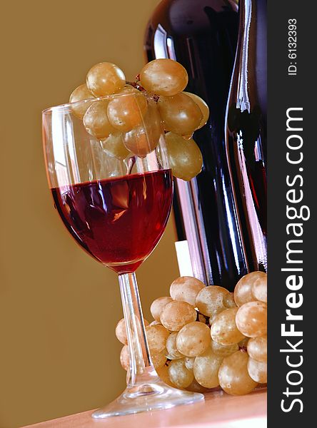 Red wine glass with grapes cluster and bottle. Red wine glass with grapes cluster and bottle