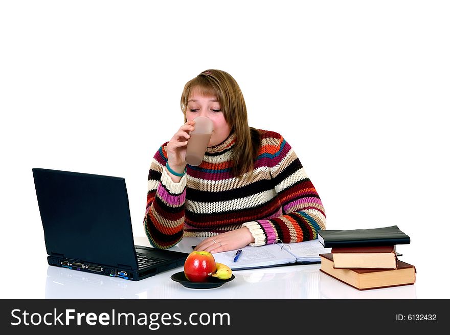 Teenager student doing homework with laptop and books on desk, with background, reflective surface