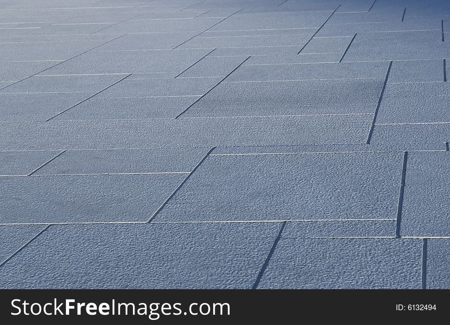 Abstract, perspective pattern of blueish grey stone tiles. Sharpness drops towards the back of the photo. Abstract, perspective pattern of blueish grey stone tiles. Sharpness drops towards the back of the photo.