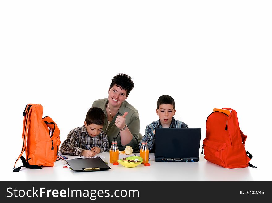 Two young boys doing together studying and homework with the support of the mother. Two young boys doing together studying and homework with the support of the mother