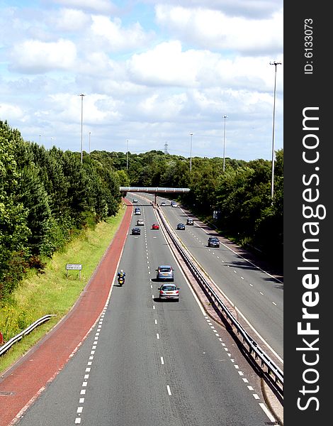 A busy road photograph on a sunny day