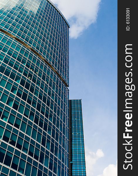 Corporate building in beautiful perspective against dynamic partially clouded sky. Corporate building in beautiful perspective against dynamic partially clouded sky