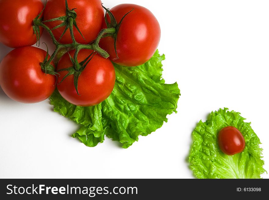 Big and cherry tomatoes on paper