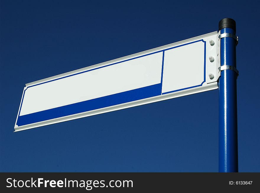 Blank street sign over a blue sky