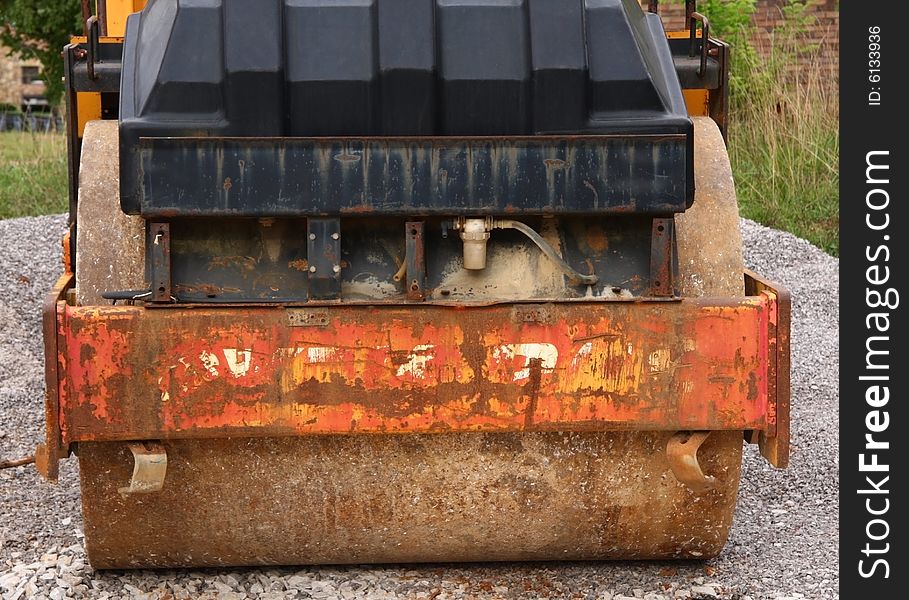 Front of an old, rusted, beat up, steamroller.