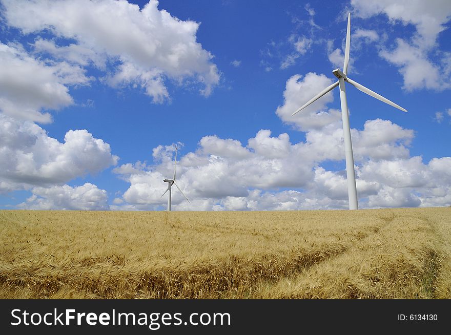 Two wind turbine in barley field, near Toulouse