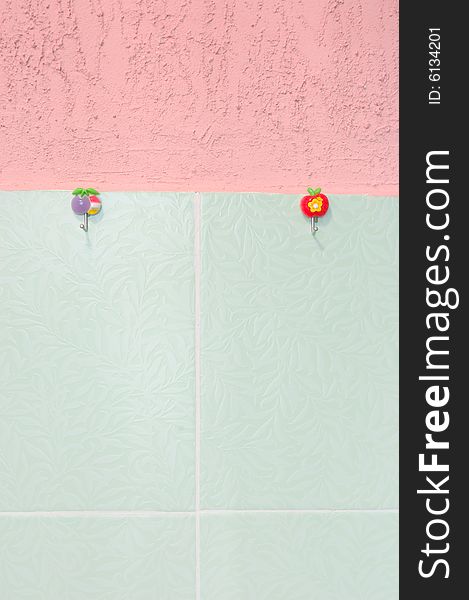 Pink stucco and green tiled wall.