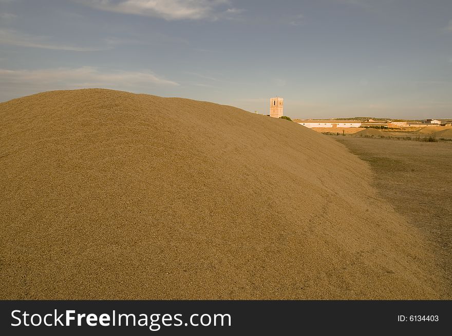 Description:
After collecting the graing, farmers pile it on the ground. They form a huge \mountains\. From this place (called \era\ in spanish), where they threshed the grain many years ago, carry it to stores. The shot was taken when the sun was very low. The light is quite red. In the background it can be seen the Church of the village (VillabrÃ¡gima - Valladolid - Spain). Description:
After collecting the graing, farmers pile it on the ground. They form a huge \mountains\. From this place (called \era\ in spanish), where they threshed the grain many years ago, carry it to stores. The shot was taken when the sun was very low. The light is quite red. In the background it can be seen the Church of the village (VillabrÃ¡gima - Valladolid - Spain)