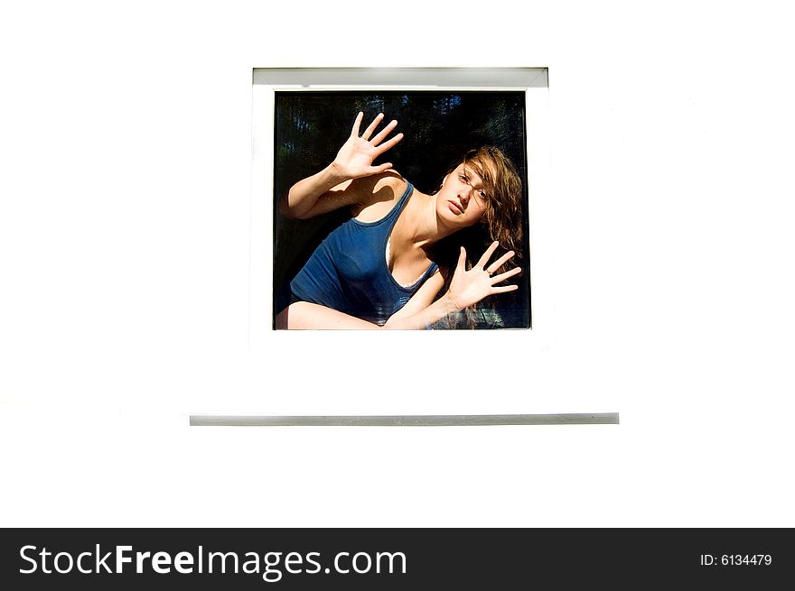 Young woman looking through the window, white background. Young woman looking through the window, white background