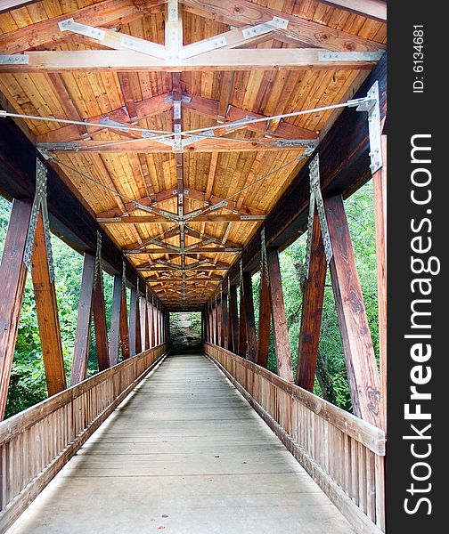 An old wood covered bridge over a river. An old wood covered bridge over a river