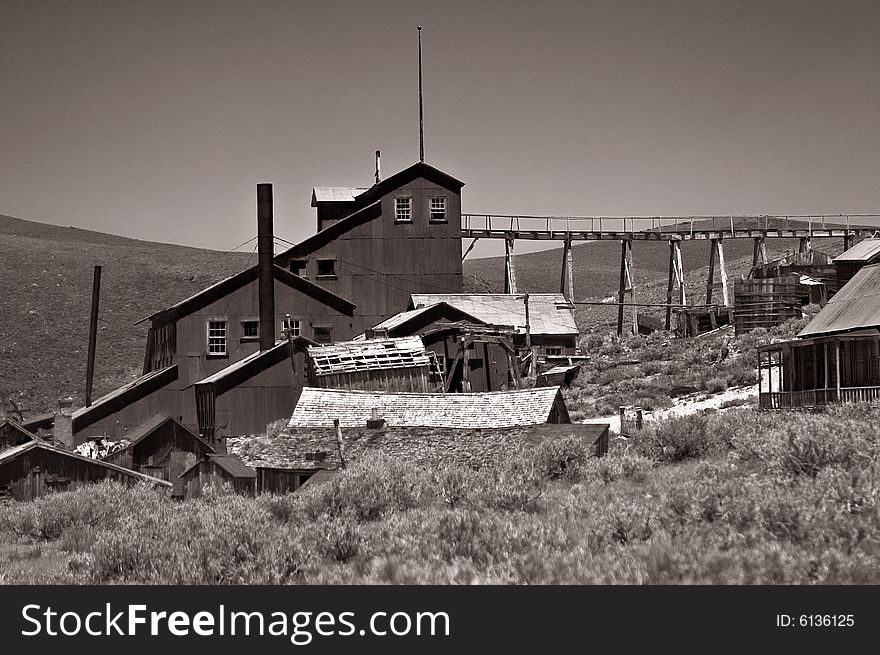 This is a black and white photograph of an abandoned stamping mill at Bodie, California, a ghost town and state park.