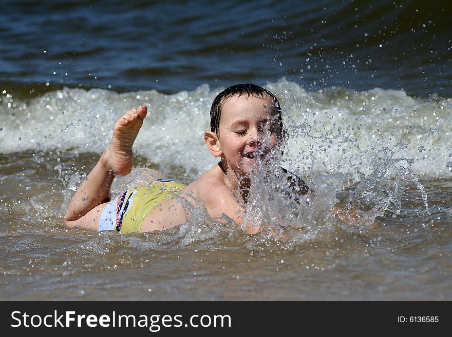 4 years old boy playing in the sea. 4 years old boy playing in the sea