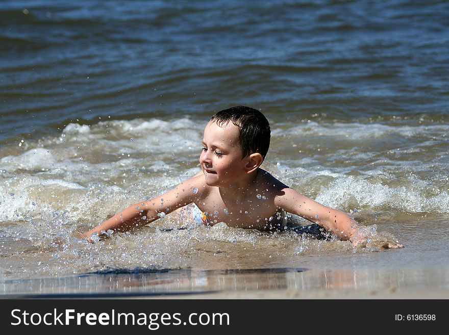 Child, Water And Fun. Beach Fun.