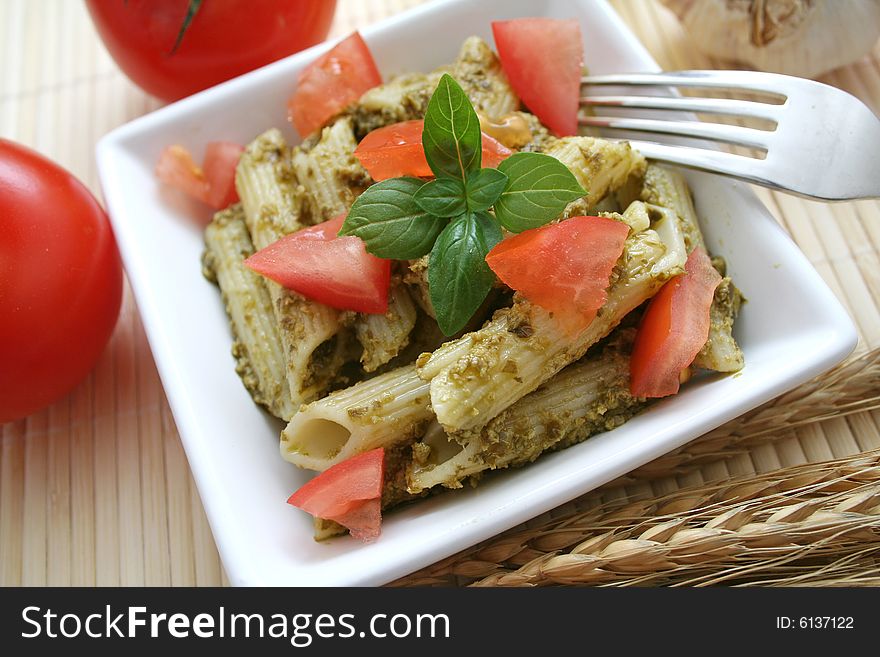 A Meal of noodles, Pesto and some tomatoes. A Meal of noodles, Pesto and some tomatoes