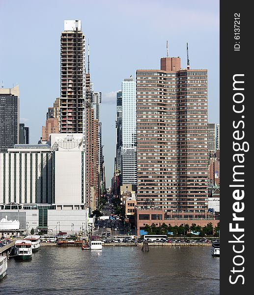 The view along the street through skyscrapers up to the other side of Manhattan, New York City. The view along the street through skyscrapers up to the other side of Manhattan, New York City.