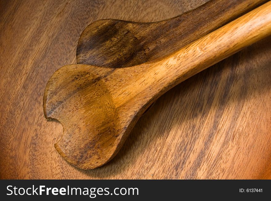 Wooden plate with two wooden spoons. Wooden plate with two wooden spoons