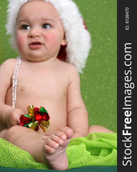 Christmas Baby playing with decorations.  FOCUS on Foot