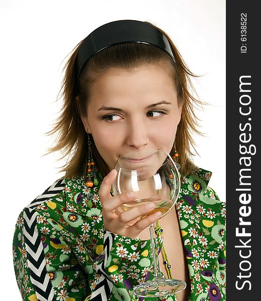 Young thoughtful woman with glass of white wine and in green coat with flowers is looking one's right side. Young thoughtful woman with glass of white wine and in green coat with flowers is looking one's right side.