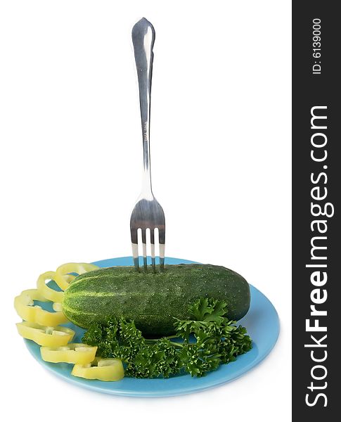 Fork and cucumber and sliced paprika on a plate. Fork and cucumber and sliced paprika on a plate