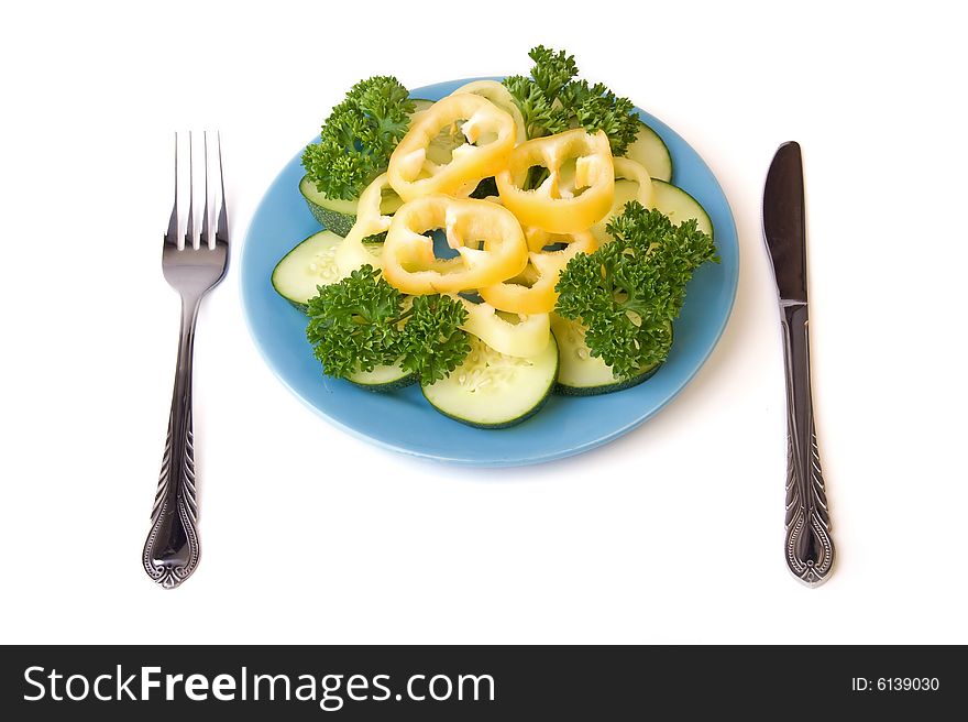 A photo of blue plate, vegetables on it and covers near it. A photo of blue plate, vegetables on it and covers near it