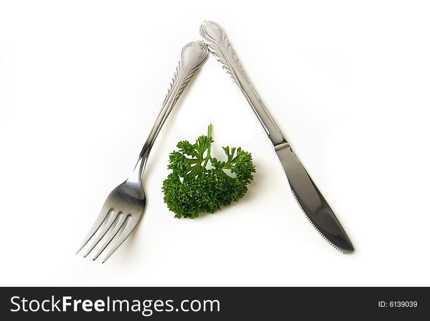 Green fresh parsley and fork and knife. Green fresh parsley and fork and knife