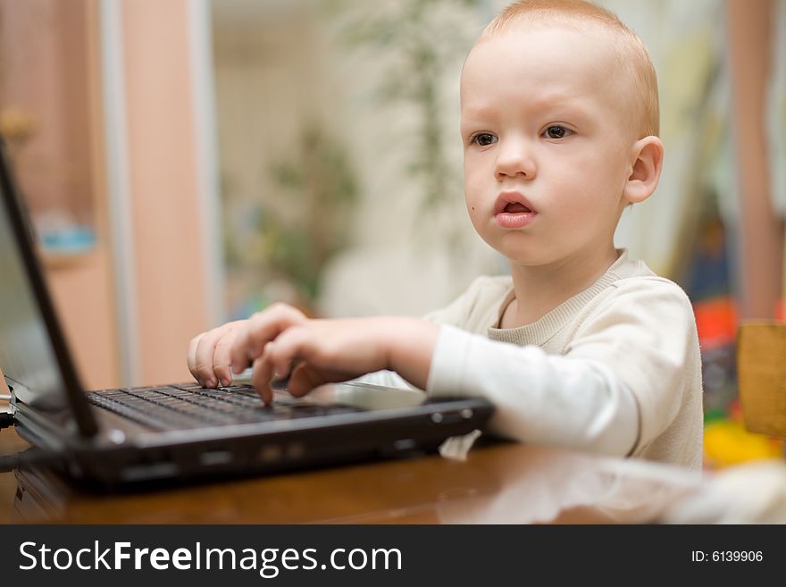 Little Boy Typing Text On Laptop At Home