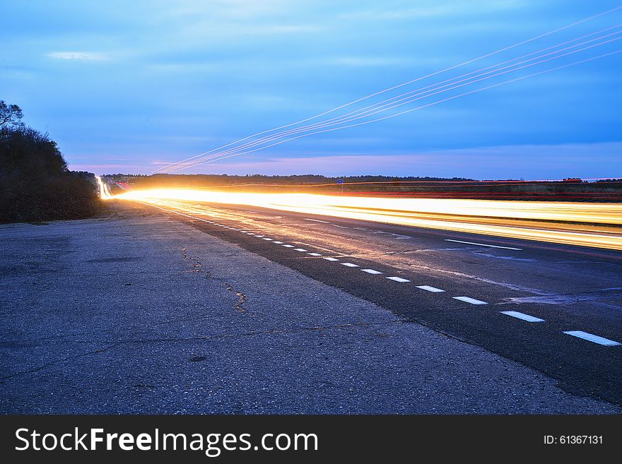 Streaks of light from car headlights on the road