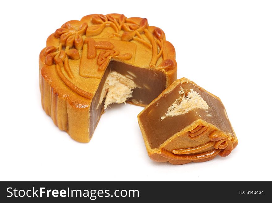 A mooncake slice into pieces over white background.