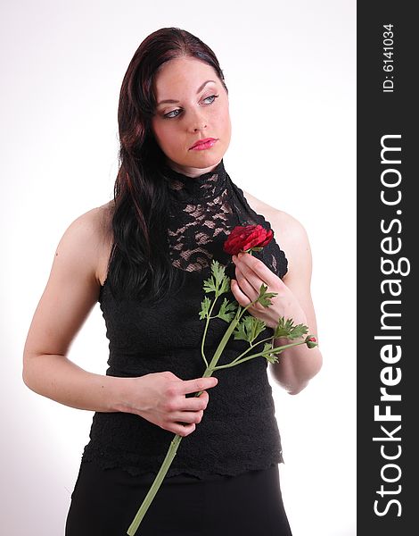 Beautiful young woman holding a rose, studio photo. Beautiful young woman holding a rose, studio photo