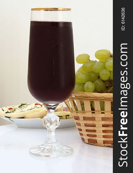 Red wine in glass with white grape