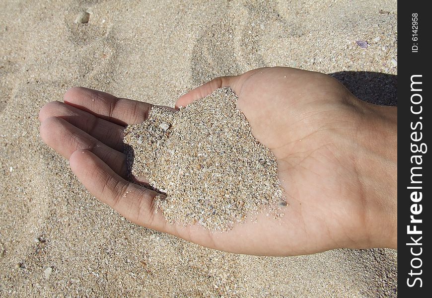 Men hand whis the sand