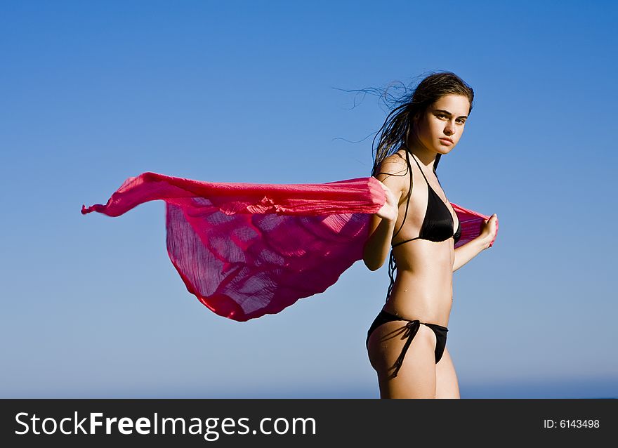 Beautiful bikini dressed woman feeling the freedom of the wind. Beautiful bikini dressed woman feeling the freedom of the wind