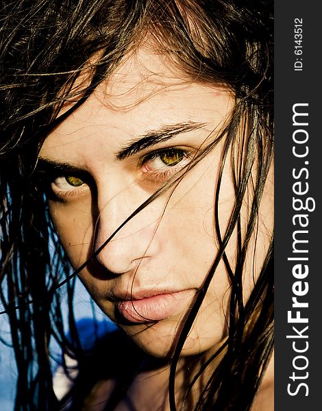 Beautiful green eyed woman portrait with wet hair.