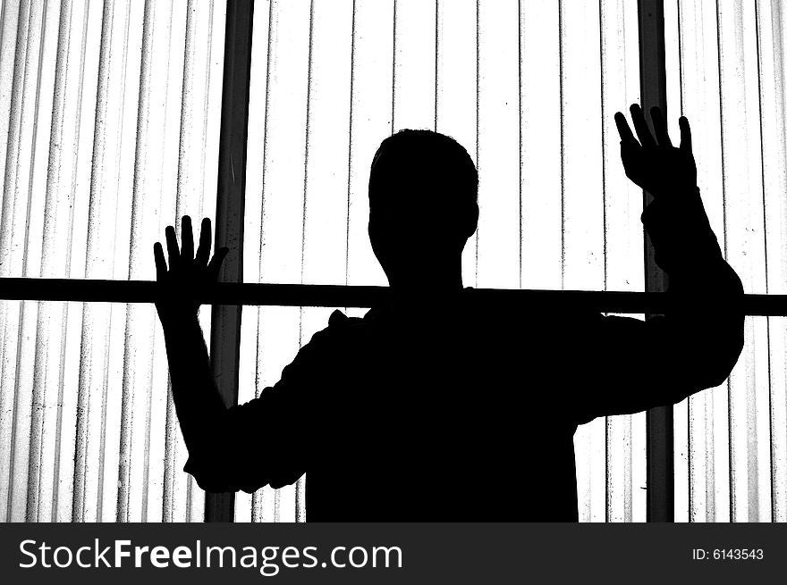 Silhouette of young man with his hands in the air with interesting textured translucent background. Silhouette of young man with his hands in the air with interesting textured translucent background.