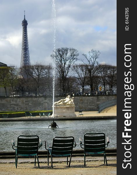 A lonely, empty chairs in the Tuileries Garden, facing the Eiffel Tower