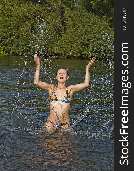 Young woman swimming in a river in the summer. Young woman swimming in a river in the summer