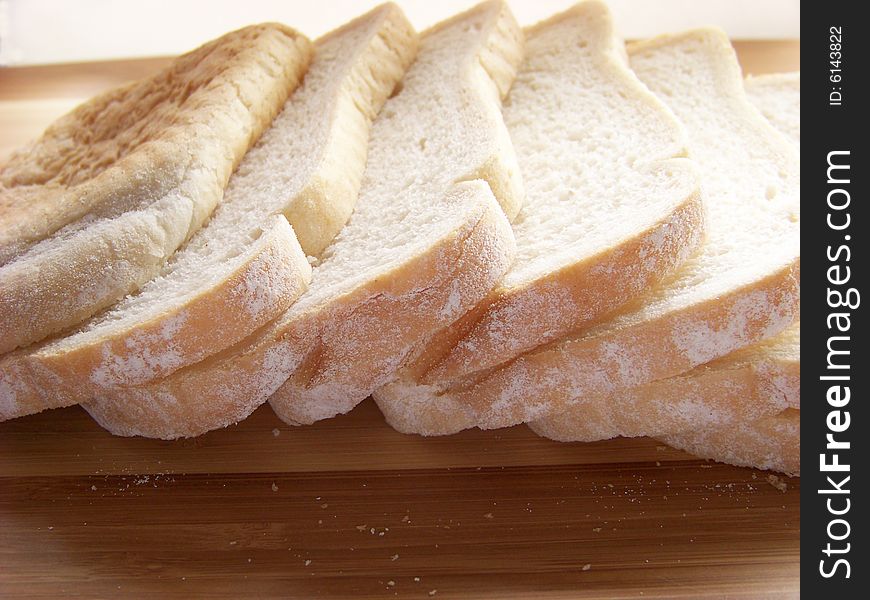 Sliced white bread on plank
