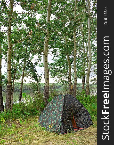 Preparation for accommodations and recreation. In the shade of trees near the river tent set, double. Preparation for accommodations and recreation. In the shade of trees near the river tent set, double.