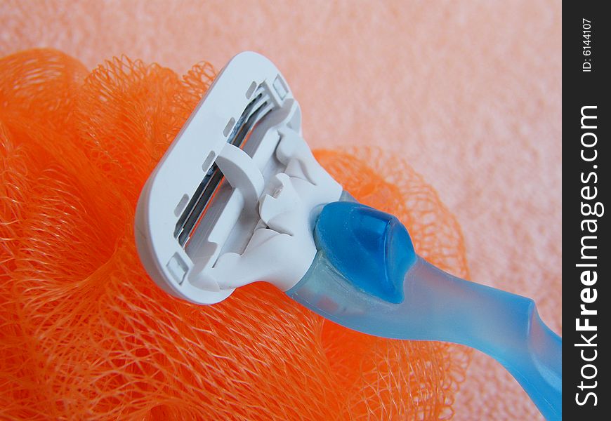 Soap  sponge and  razor on a pink background