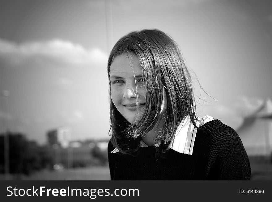 A black and white portrait of a smiling girl with a fringe. A black and white portrait of a smiling girl with a fringe