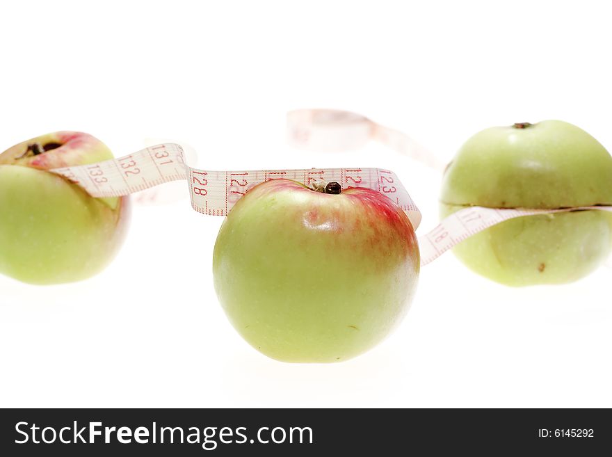 Apples and measuring tape isolated on white background.