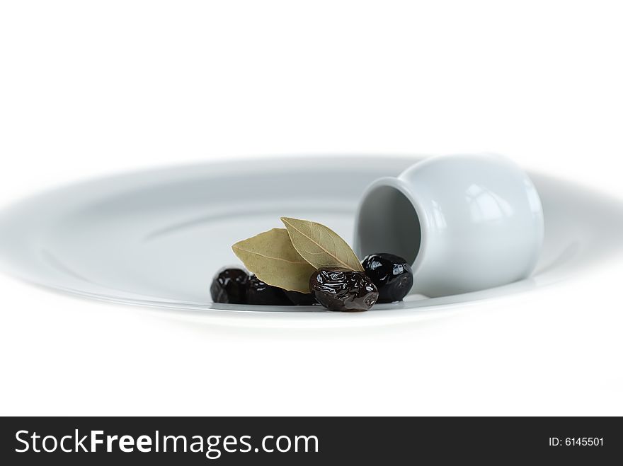 Black olives on white service plate, beauty of black