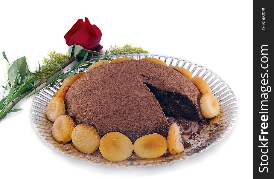 Delicious damson plum and chocolate cake with a rose in white background. Delicious damson plum and chocolate cake with a rose in white background